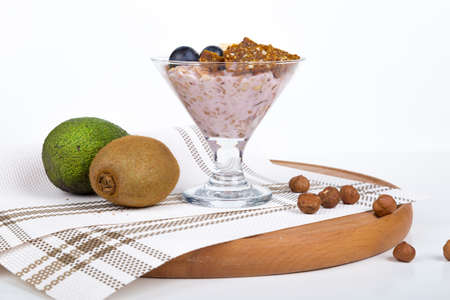 Close up view of cup and raw vegan energy sweets, bars with mix of fruits and nuts. Lifestyle healthy eating concept with breakfast or snack.の写真素材