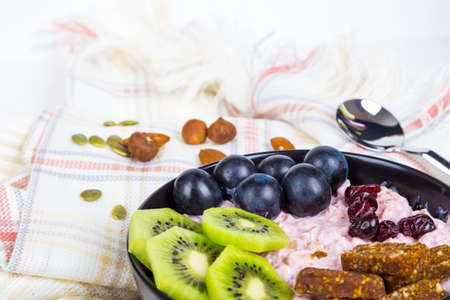 Healthy lifestyle, mix of energy fruits and dried nuts in cup, breakfast or morning snack concept, isolated on white background.の写真素材