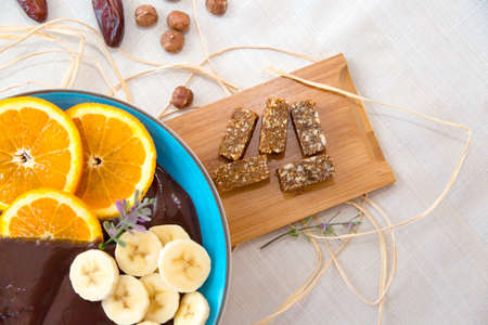 Top view of mixed fruits in cup served in blue plate with cacao cream.の写真素材