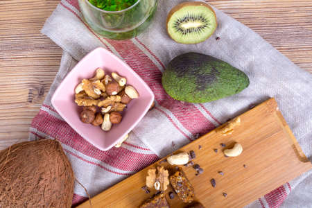 Healthy food concept, with coconut, mixed nnuts and some fruits on wooden table.の写真素材