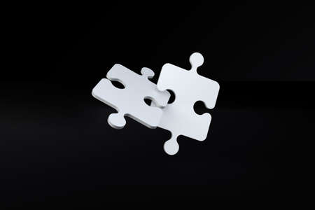 Two jigsaw puzzle pieces inside each on black background.の写真素材