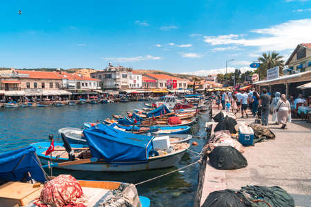 IZMIR,  TURKEY - JUNE 05, 2019 : Fishing boats in touristic place of Aegean Region in Phocaea Town with old and historical, traditional architecture buildings. Phocaea is ancient city in old dates.のeditorial素材