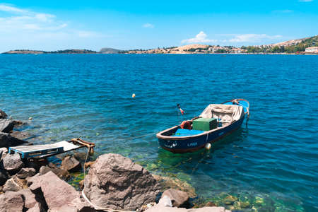 IZMIR,  TURKEY - JUNE 05, 2019 : Fishing boats in touristic place of Aegean Region in Phocaea Town with old and historical, traditional architecture buildings. Phocaea is ancient city in old dates.のeditorial素材