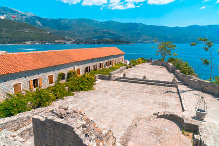 Panoramic view of old town Budva, Montenegro on from citadel ancient walls near Balkan mountains and Adriatic Sea on summer day, cloudy sky background.の写真素材