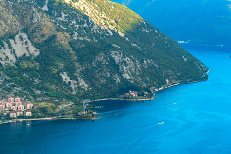 Scenic panoramic landscape view of historic town on Bay of Kotor, Montenegro with mountains at...