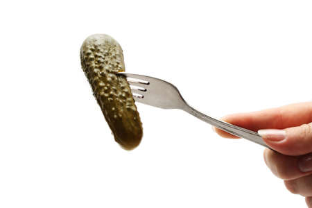 Salted cucumber on the plug. Close-up. Isolated on a white background.の写真素材