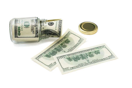 Money in a glass jar. Close-up. Isolated on a white background.の写真素材