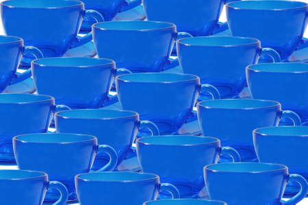 Blue glass tea cups in a row on a white background.の写真素材