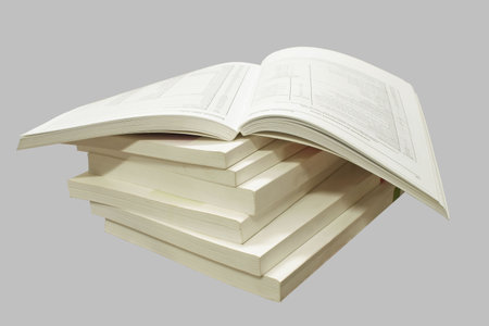 A stack of catalogs, isolated on a gray background.