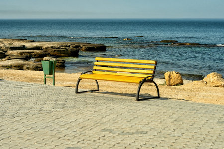 Empty wooden bench at the seaside