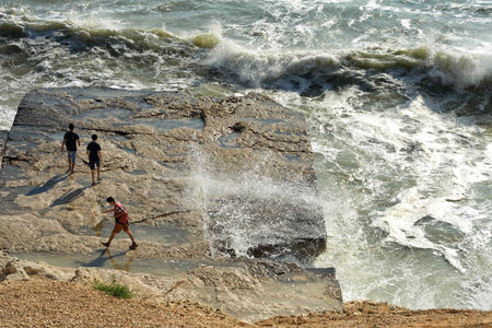 Young people on the rocky shore of the Caspian Seaの写真素材