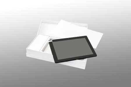 Tablet PC in new packaging. Isolated on a gray background.の写真素材