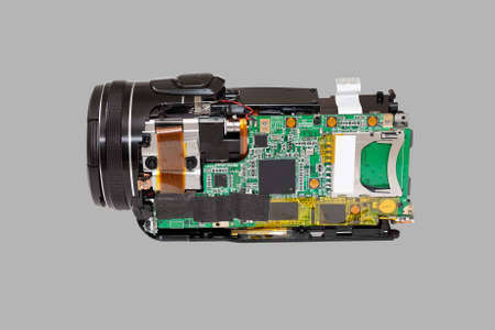 Disassembled compact camcorder. Close-up. Isolated on a gray background.の写真素材