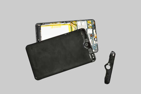Disassembled tablet computer. Isolated on gray background.の写真素材