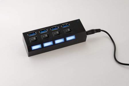 USB hub with backlight and switch. Close-up on a white background.