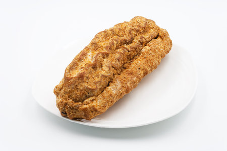Cake eclair on a white plate. On a white background.