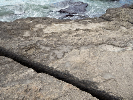 Rocky shore of the Caspian Sea. The texture of the stone. Sawing in a rockの写真素材