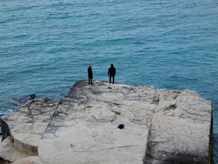 Two people on the shore of the Caspian Sea.