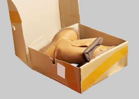 Orange work shoes in a cardboard box.