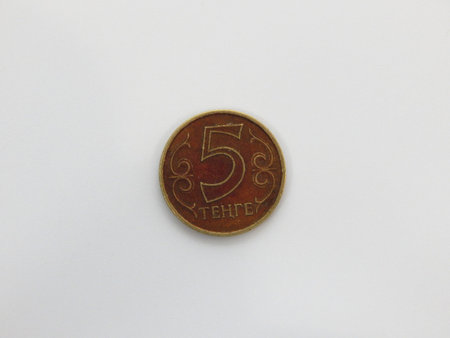 Old coin five tenge covered with brown patina. Kazakhstan.