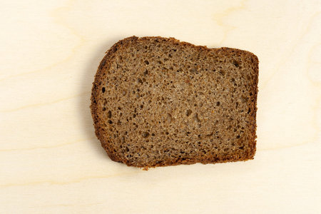 Slice of bread on a wooden background.