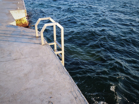 Ladder made of stainless steel into the water. Caspian Sea.