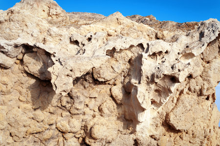 Surface sandy rock. Rocky shore of the Caspian Sea.