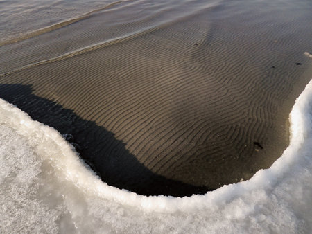 Ice on the sandy shore of the Caspian Sea. Kazakhstan. Mangistau region. 22 November 2019 year.の写真素材