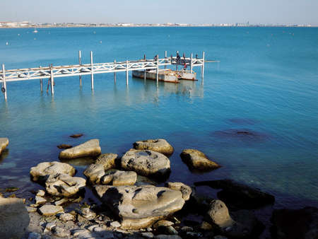 Loading an iron section onto a floating platform. Construction of the pier. Kazakhstan. Aktau city. 08 October 2019 year. Work without protective equipment.のeditorial素材