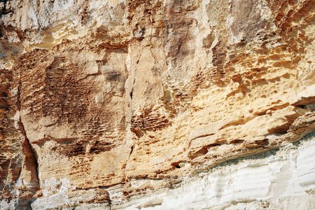 Surface sandy rock. Rocky shore of the Caspian Sea.
