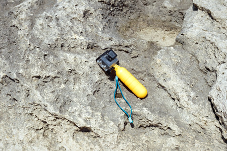 Compact underwater photo and video camera. Rocky shore.の写真素材