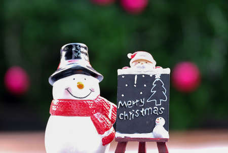 Snowman and Santa doll with merry christmas board.の写真素材