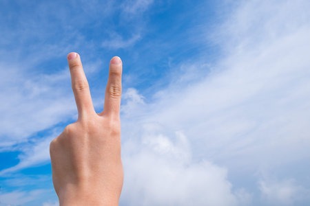 Hand with two fingers up in the peace or victory symbol