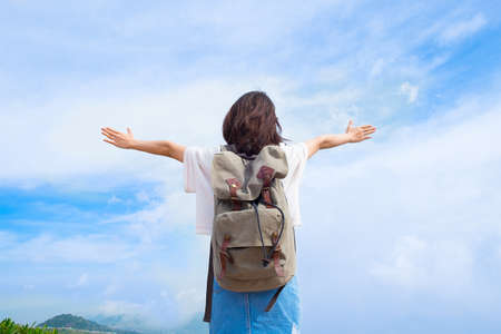 Back side of traveler girl looking at the blue sky, travel and active lifestyle conceptの写真素材