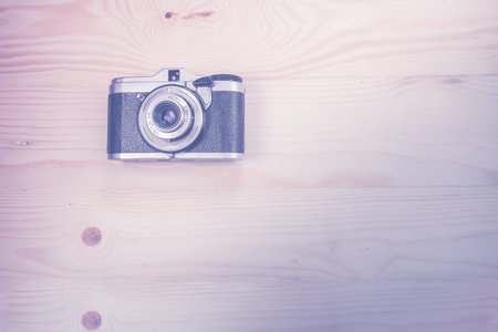 Vintage camera on wooden background. Vintage toneの写真素材