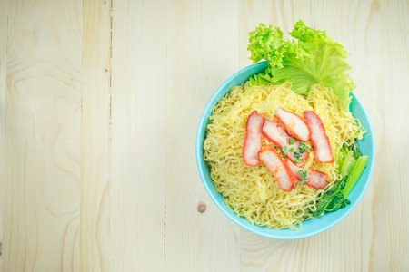 Yellow noodle with sliced red pork.