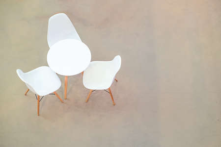 White circle table and chairs on carpet floor. view from aboveの写真素材