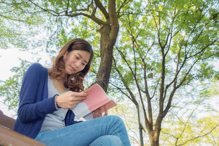 The woman reading in the park.の写真素材
