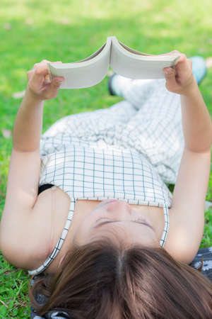 The woman reading in the park.の写真素材