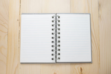 Open notebook on wooden table.