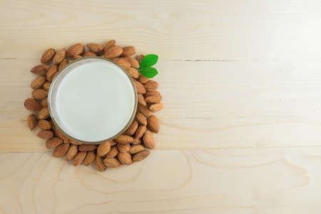 Almond milk in a glass with almonds.の写真素材