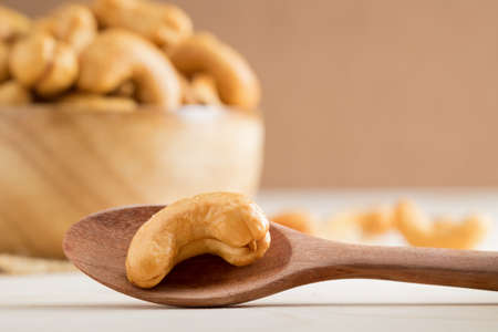 Close up shot of cashew nut on wooden spoon.の写真素材