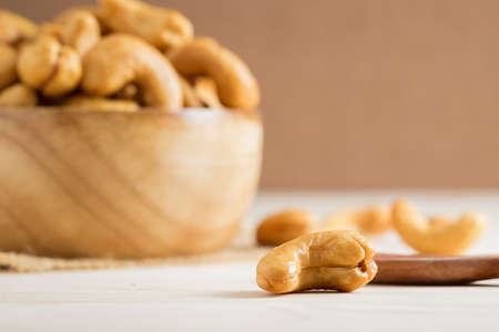 Close up shot of cashew nut on wooden table.の写真素材