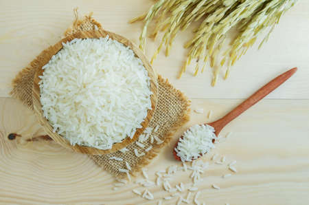Thai jasmine rice in bowl on wooden table.の写真素材
