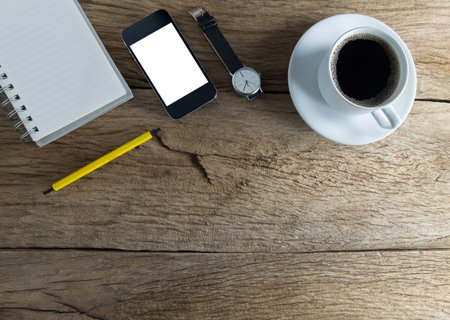 Still life photography, Black coffee with notebook,smartphone on wooden table. top view