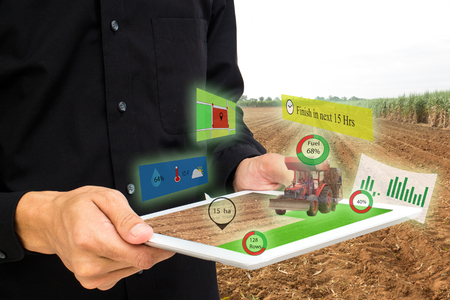 iot,internet of things, agriculture concepts,farmer use 3d pop up of augmented reality to manage,analysis and keep data in the farm or fieldの写真素材