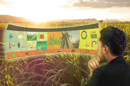 iot,internet of things, agriculture concepts,farmer use augmented reality on screen display to manage, analysis and keep data in the field or farmの写真素材