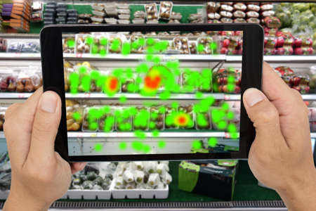 internet of things marketing concepts,man holding tablet to know the data of eye contract of customer by augmented reality technology,to collect and analysis data that customer like and wish to buyの写真素材