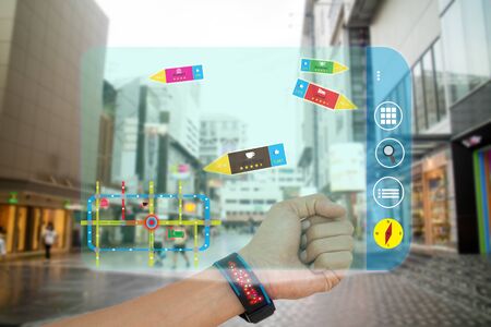 iot, internet of things,concept man use smart watch with augmented reality technology to show how far,ratio of vote,and how many people like by application,while travelの写真素材