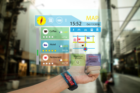 iot, internet of things,concept man use smart watch with augmented reality technology to show the map, recommended place with review including like,ratio of vote,and transport vehicle,while travelの写真素材